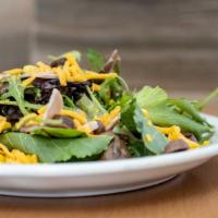 Market Salad · Organic mixed greens, Canadian bacon, sweetcorn, black olives, and cheddar cheese.