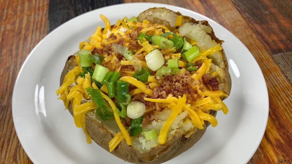 Baked Potato · Comes with butter, cheese, sour cream, bacon bits and chives.