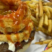 Buffalo Blue Cheese Burger · Topped with blue cheese, crispy fried onion rings and buffalo sauce.
