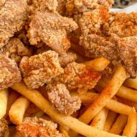 Popcorn Chicken & French Fries · Marinated bite sized chicken served with french fries.