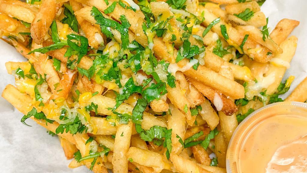 Garlic Fries · Crispy fries topped with garlic seasoning shredded mozzarella cheese and cilantro.