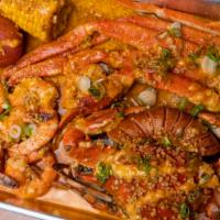 Captains Feast Without Blue Crab · 1 snow crab cluster, 10 shrimp, a corn, potato, and sausage boiled and tossed in our garlic ...