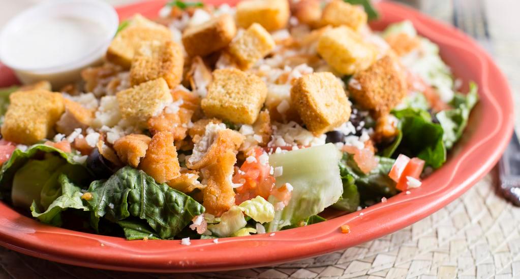 Southwest Chicken Salad · Choice of Crispy Chicken Tenders or Grilled Chicken Breast, Shredded Cheese, Diced Tomatoes, Croutons, Tortillas Chips.