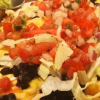 Loaded Nachos · Chips covered with queso, shredded lettuce, pico de gallo, topped with sour cream and guacam...