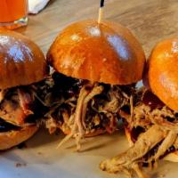 Pulled Pork Sliders · 16 hour smoked and pulled pork butt served with BBQ sauce.
