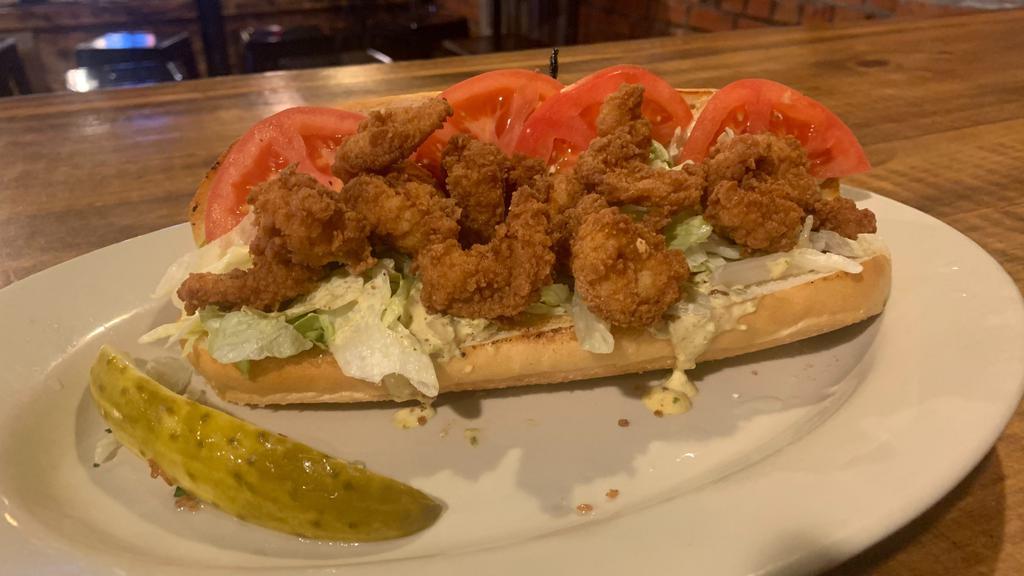 Shrimp Po'Boy · Beer battered fried shrimp, lettuce, tomato, and homemade cajun cream sauce on a French roll. Served with your choice of side.