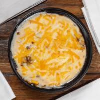 Tamale Pie (1) · Fritos, TX beef chili, queso, and your choice of 1 tamale. Topped with shredded cheese. Noth...