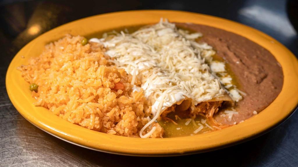 Enchiladas Dinner · 3 enchiladas with chicken, beef or cheese topped with red or green sauce, sour cream, queso fresco on top with rice and beans.