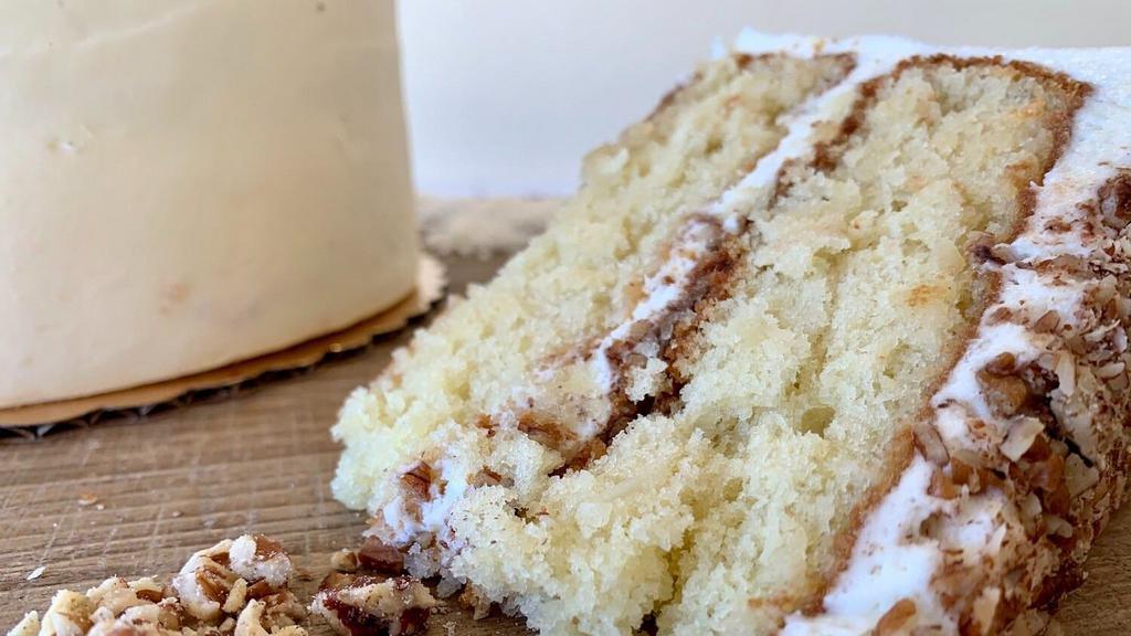 Italian Cream Slice · Coconut cake frosted and filled with cream cheese buttercream, filled and topped with crushed pecans.