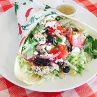 Greek Wrap · Chicken, feta, red onion, olives, tomatoes, lettuce, and herbs.