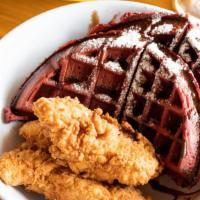 Chicken & Waffles-Red Velvet · Three chicken tenders with waffle and sauce.