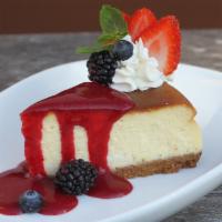 Ny Style Cheesecake · Delicious homemade with berry coulis and fresh whipped cream.
