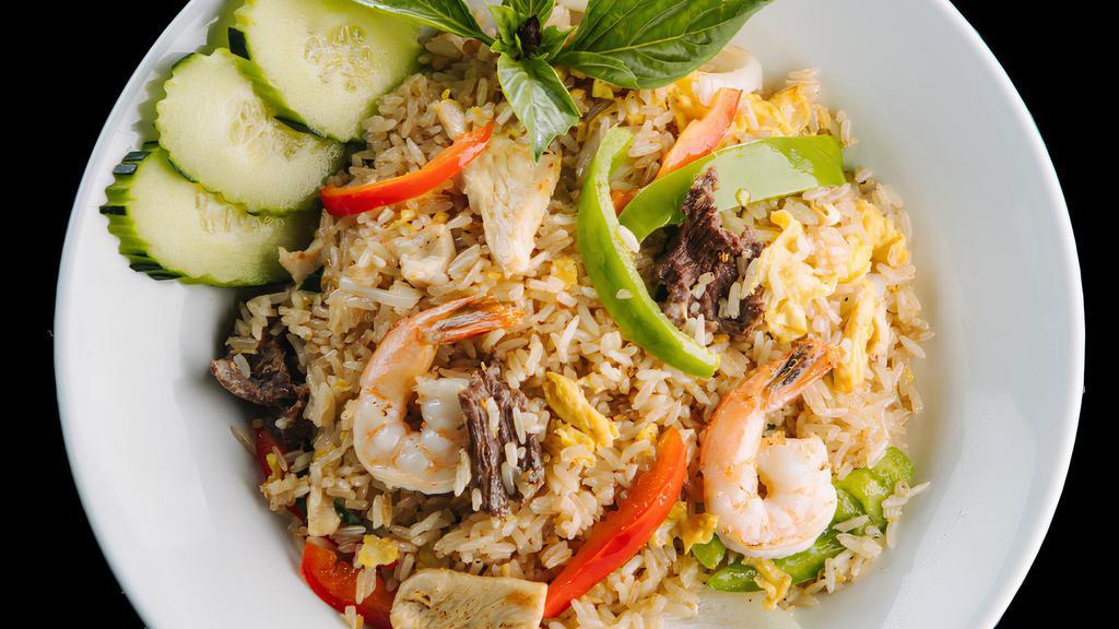 Spicy Basil Fried Rice · Eggs, bell pepper, onions, fresh chili, basil leaf garnish with cucumber and cilantro