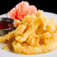 Fried Calamari · Fried calamari strips served with spicy sweet and sour and ground peanuts.