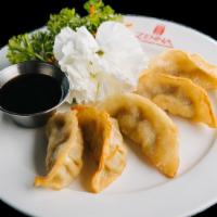 Gyoza (Steamed Or Fried) · Japanese chicken pot sticker served with ginger soy sauce.