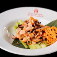 Japanese Squid Salad · Shredded squid marinated with ginger and seaweed in sweet sesame chili vinaigrette.