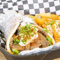 Traditional Gyro Sandwich · Beef and lamb with lettuce, tomatoes, onions, and tzatziki sauce in a pita.