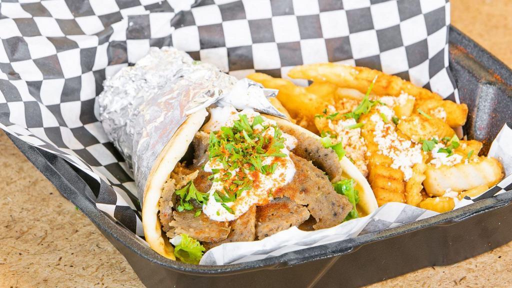 Traditional Gyro Sandwich · Beef and lamb with lettuce, tomatoes, onions, and tzatziki sauce in a pita.