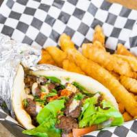 Shawarma Beef Gyro Sandwich · Beef with lettuce, tomatoes, onions, and tahini sauce in a pita.