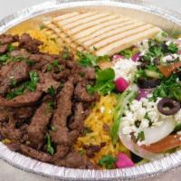 Shawarma Beef Plate · Served with rice, salad, hummus, pita bread, and tahini sauce.