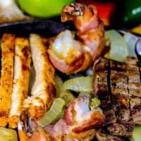 Juanita'S Fajitas For (1) · Chicken, steak, two bacon wrapped shrimp served with rice, charros beans, guacamole, sour cr...