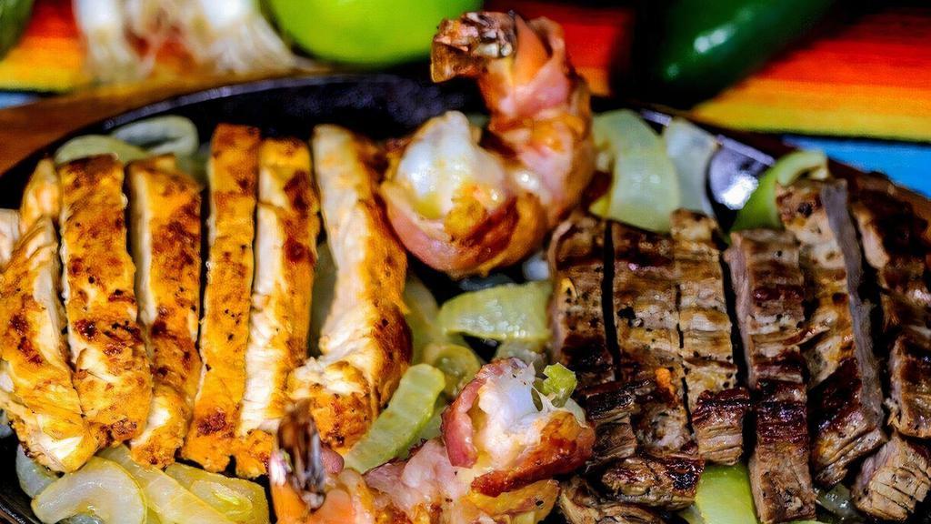 Juanita'S Fajita For (1) · Chicken, beef & two bacon wrapped shrimp served with rice, charros beans, guacamole, sour cream, and cheese.