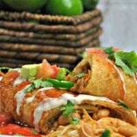 Fajita Beef Chimichanga · Covered with ranchero sauce. Served  with  refried beans