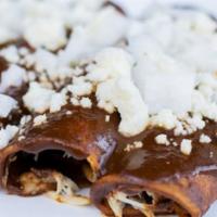 Enchiladas De Mole · Filled w/ chicken covered w/ mole sauce & topped w/sour cream and queso fresco. Served with ...