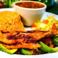 Pechuga Rellena · Grilled chicken breast stuffed with pico de gallo, avocado and cheese served with rice and c...