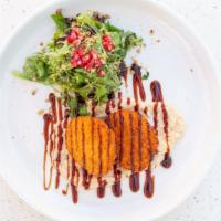 Fried Goat Cheese · Pistachio-crusted goat cheese, pomegranate green olive salad, tahini sauce.