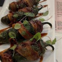 Stuffed Jalapeños  · Four jalapeños stuffed with brisket & pimento cheese, wrapped in bacon.