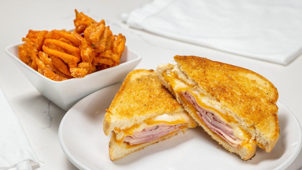 Grilled Ham & Cheese · Gruyere, smoked cheddar, Swiss cheese and ham on sourdough bread with dijon spread