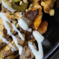 Large Volcano Fries · Melted cheddar cheese on the top of a 1/2 crinkle cut fries, seasoned ground beef, jalapeno'...