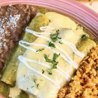 Enchiladas Verdes · Shredded Chicken Roasted Tomatillo Sauce, Refried Beans and Mexican Rice.