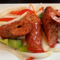 Sheek Kabab · Tender minced lamb seasoned with mild spiced skewered and cooked in tandoor - a charcoal cla...