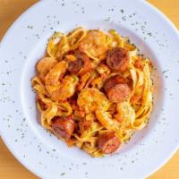 Voodoo Pasta · Hot. Spicy Cajun sausage and large shrimp in a white wine and tomato cream sauce over fettuc...