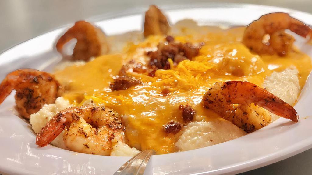 Shrimp And Grits · Blackened shrimp and creamy southern grits smothered with our tasty lobster bisque, bacon crumbles and cheese.