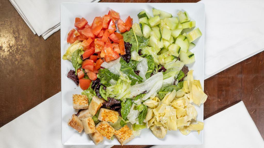 Tuscan Salad · Mixed Field Greens topped with Tomatoes, Cucumbers, Artichoke Hearts and Croutons