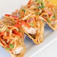 Paleo Rainbow Slaw Salmon Tacos · Pan-seared sustainably sourced salmon topped with our rainbow slaw of jicama, red onion, shr...