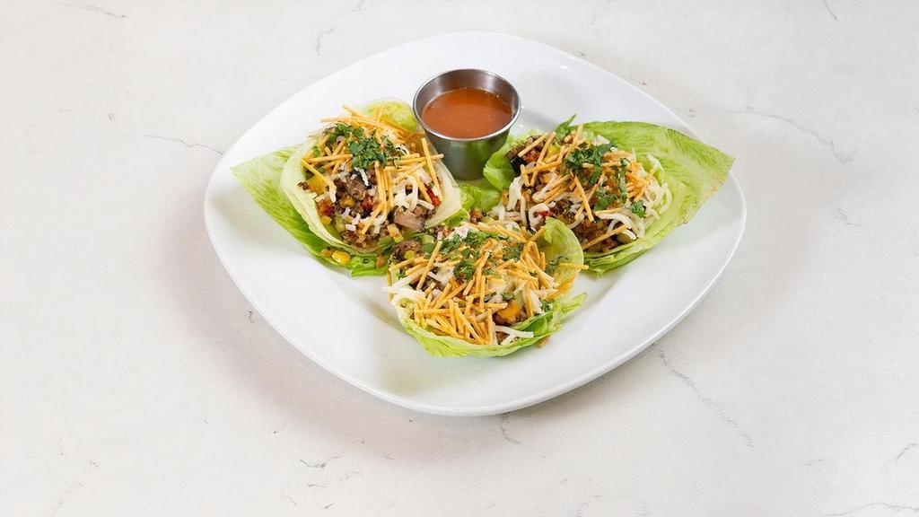 Veggie Lettuce Wraps [Gf][Veg] · three baby iceberg lettuce wraps filled with yellow & red bell peppers, organic quinoa, onion, celery, mushrooms, zucchini, corn, garlic, cilantro & sesame oil; topped with queso fresco, crispy quinoa strips & served with savory ginger sauce