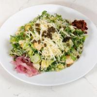 Kale Caesar Salad · crisp romaine lettuce & kale mixed with crispy capers, caramelized red onions, sun-dried tom...
