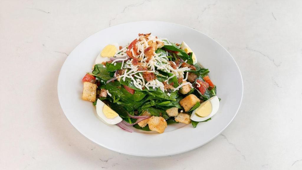 Spinach Salad · fresh spinach, hard boiled eggs, bacon, diced tomatoes, red onions, sliced cremini mushrooms, croutons & queso fresco; tossed with our warm bacon vinaigrette