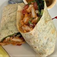 Buffalo Wrap · Golden fried chicken tender, tossed in buffalo sauce. With mixed greens, diced tomatoes, ble...