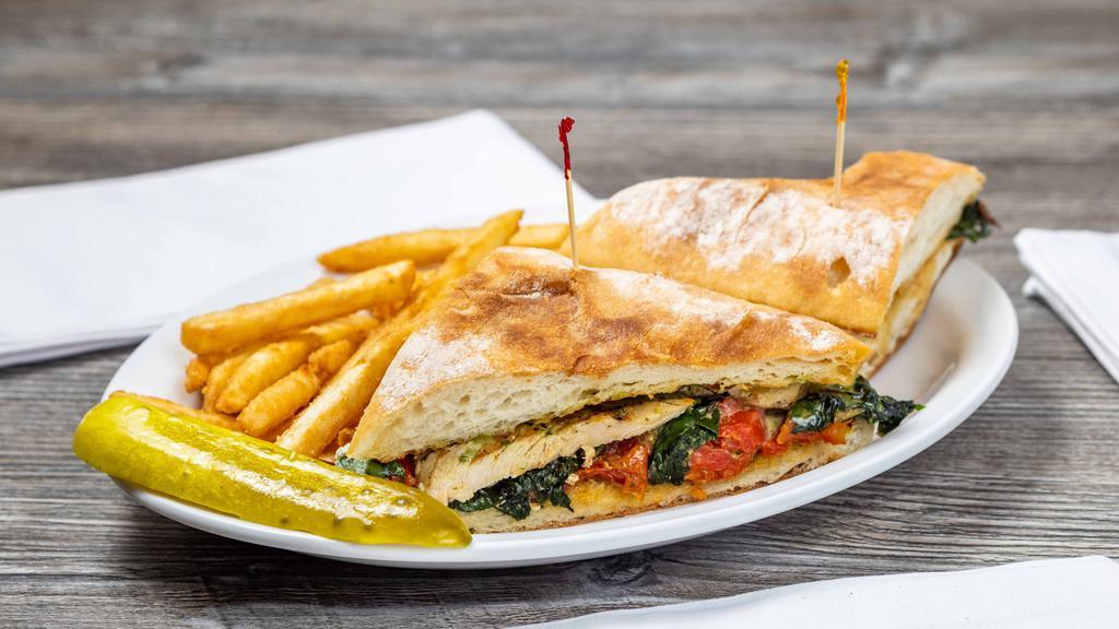Italian Panini · Grilled chicken breast with roasted red peppers, spinach, roasted tomatoes, feta cheese and pesto ,mayo on ciabatta bread.