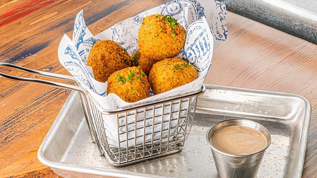 Mac & Cheese Brisket Balls · Stuffed with mac & cheese, smoked brisket, cheddar, and fried to perfection. Served with BBQ Ranch dipping sauce.