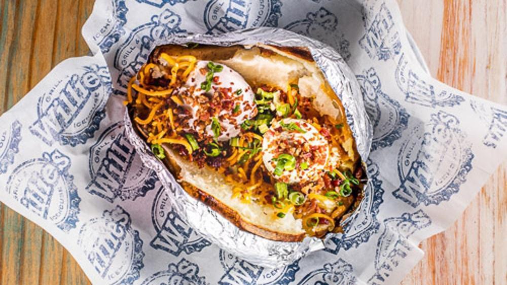 Baked Potato · Large baked potato with sour cream, butter, cheddar cheese, bacon bits, and chives.