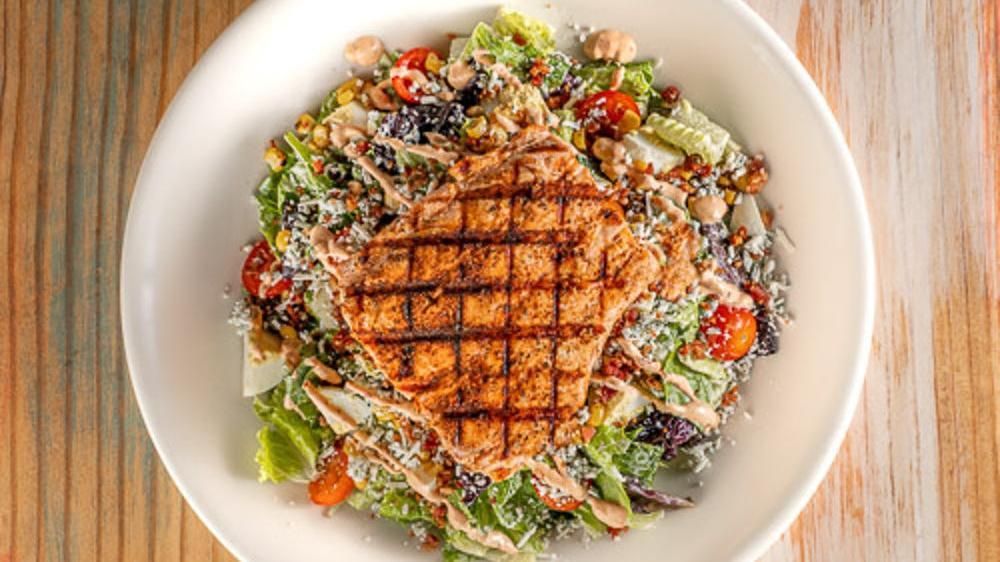 Icehouse Salmon Cobb · $19.29. Spring mix, iceberg, & romaine lettuce topped with chicken, bacon, street corn, diced egg, cherry tomatoes, gorganzola crumbles, and a creamy chipotle sauce