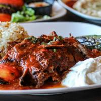 Iskender Kebab · Gyro meat over a bed of sliced pita topped with tomato sauce and served with grilled tomatoe...
