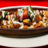 Yogurt Kebab · Your choice of adana or chicken kebabs over a bed of sliced pita topped with garlic-yogurt a...