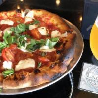 Margherita · Red sauce topped with fresh mozzarella, basil, and red cherry tomatoes.